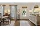 Elegant dining room with hardwood floors, decorative mirror, and ample natural light, perfect for entertaining guests at 515 Saint Barbaras Nw Ln, Marietta, GA 30064