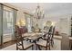 Spacious dining room featuring a chandelier, hardwood floors, and large windows, ideal for Gathering gatherings and formal dinners at 515 Saint Barbaras Nw Ln, Marietta, GA 30064