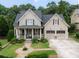 Charming two-story home with a welcoming front porch, well-manicured lawn, and a two-car garage at 515 Saint Barbaras Nw Ln, Marietta, GA 30064