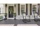 Inviting front porch with rocking chairs, potted plants, and decorative details, offering a cozy outdoor space at 515 Saint Barbaras Nw Ln, Marietta, GA 30064
