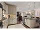 Open-concept kitchen with island, pendant lighting, and modern appliances, seamlessly connected to the living space at 515 Saint Barbaras Nw Ln, Marietta, GA 30064