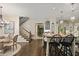 Bright kitchen featuring an island with bar seating, hardwood floors, and an adjacent staircase at 515 Saint Barbaras Nw Ln, Marietta, GA 30064