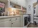 Bright laundry room with modern washer and dryer, granite countertops, and ample storage space at 515 Saint Barbaras Nw Ln, Marietta, GA 30064
