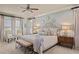 Serene primary bedroom with tufted headboard, natural light, and sitting area, creating a relaxing retreat at 515 Saint Barbaras Nw Ln, Marietta, GA 30064