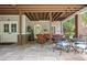 Covered patio area with comfortable seating, a dining table, and views of the landscaped yard at 515 Saint Barbaras Nw Ln, Marietta, GA 30064