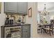 Elegant wet bar area with marble countertop, wine cooler, and stylish cabinets, perfect for entertaining guests at 515 Saint Barbaras Nw Ln, Marietta, GA 30064