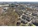 Community aerial view featuring modern townhomes nestled among trees with the city skyline in the distance at 6838 Prelude Dr, Atlanta, GA 30328