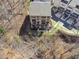 Birds eye view of a brick townhome surrounded by trees and a parking area at 6838 Prelude Dr, Atlanta, GA 30328