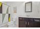 Bathroom featuring a modern vanity, toilet, and decorative shower curtain at 6838 Prelude Dr, Atlanta, GA 30328