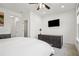 Bright bedroom features a dark wood dresser, mounted tv, and hardwood floors at 6838 Prelude Dr, Atlanta, GA 30328