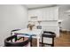 Bonus space features white cabinets, hardwood floors, and a game table at 6838 Prelude Dr, Atlanta, GA 30328