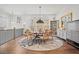Spacious dining room with large windows, hardwood floors and an elegant round dining table set at 6838 Prelude Dr, Atlanta, GA 30328