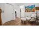 Elegant hallway with hardwood floors, modern art, and a sitting area at 6838 Prelude Dr, Atlanta, GA 30328