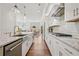 Gourmet kitchen featuring a center island, white cabinetry, stainless steel appliances, and hardwood floors at 6838 Prelude Dr, Atlanta, GA 30328