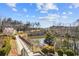 Scenic view of the community waterfront with lush landscaping, walking path, and clear skies at 6838 Prelude Dr, Atlanta, GA 30328