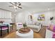 Open-concept living room with hardwood floors, a ceiling fan, and view of the kitchen at 6838 Prelude Dr, Atlanta, GA 30328