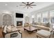Bright living room with fireplace, comfortable seating, natural light and a ceiling fan at 6838 Prelude Dr, Atlanta, GA 30328