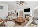 Open-concept living room with a fireplace, hardwood floors, and seamless flow to the modern kitchen at 6838 Prelude Dr, Atlanta, GA 30328