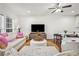 Open-concept living room with hardwood floors, ceiling fan, and a mounted television at 6838 Prelude Dr, Atlanta, GA 30328