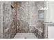Sleek walk-in shower featuring gray tile, a built-in bench, and a frameless glass door at 6838 Prelude Dr, Atlanta, GA 30328