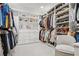 Spacious walk-in closet with custom shelving, ample storage, and a comfortable chair at 6838 Prelude Dr, Atlanta, GA 30328
