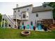 Expansive backyard featuring a patio with seating, fire pit, and lush green lawn, perfect for outdoor entertaining at 855 Hood Rd, Fayetteville, GA 30214