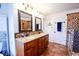A spacious bathroom featuring a tiled shower, double sinks with wooden cabinets, and granite countertops at 855 Hood Rd, Fayetteville, GA 30214