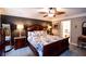 Bedroom featuring a large bed, decorative bedside lamps, and a unique leaf-inspired ceiling fan at 855 Hood Rd, Fayetteville, GA 30214