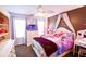 Charming bedroom features a whimsical decor, plush bedding, and a decorative ceiling fan at 855 Hood Rd, Fayetteville, GA 30214