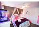 A whimsical bedroom featuring a charming mermaid theme with a decorative ceiling fan and gray accent wall at 855 Hood Rd, Fayetteville, GA 30214
