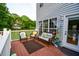 Cozy outdoor deck featuring comfortable seating and charming decor, perfect for relaxing and enjoying the outdoors at 855 Hood Rd, Fayetteville, GA 30214
