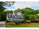 Charming two-story home with a welcoming front porch and professionally landscaped front yard at 855 Hood Rd, Fayetteville, GA 30214