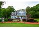 Lovely two-story home with blue shutters, a covered porch, and well-kept landscaping at 855 Hood Rd, Fayetteville, GA 30214