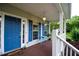 Charming front porch with blue door and shutters, and comfortable seating area at 855 Hood Rd, Fayetteville, GA 30214
