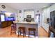 Open kitchen with granite counters, stainless steel appliances, and hardwood floors at 855 Hood Rd, Fayetteville, GA 30214