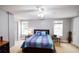 Bright main bedroom with natural light boasts a ceiling fan and neutral color scheme at 855 Hood Rd, Fayetteville, GA 30214