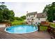 Large backyard with an above-ground pool, spacious deck, and well-maintained lawn with patio for entertaining at 855 Hood Rd, Fayetteville, GA 30214