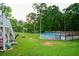 Backyard view showcasing an above ground pool with a spacious deck and a lush green lawn at 855 Hood Rd, Fayetteville, GA 30214