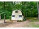 Spacious outdoor shed with double doors, blending into a wooded backyard at 855 Hood Rd, Fayetteville, GA 30214