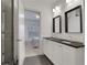 Bathroom featuring double sinks, dark countertops, and a glass shower at 2620 Middle Coray Cir, Marietta, GA 30066