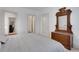 Bedroom with a bed dressed in white and grey and an antique dresser with mirror in the corner at 2620 Middle Coray Cir, Marietta, GA 30066