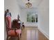 Hallway with hardwood floors, a window view to the backyard, and two antique arm chairs with a matching dresser at 2620 Middle Coray Cir, Marietta, GA 30066