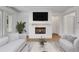 Modern living room with a white brick fireplace, large TV, and stylish decor at 2620 Middle Coray Cir, Marietta, GA 30066