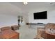 Spacious living room featuring vaulted ceilings, neutral paint, carpet, and a large wall-mounted TV at 2620 Middle Coray Cir, Marietta, GA 30066
