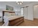 This main bedroom features hardwood floors, neutral walls, light window coverings, and an ensuite bathroom at 2620 Middle Coray Cir, Marietta, GA 30066