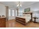 This main bedroom features hardwood floors, a white ceiling, a wooden bed frame, neutral walls, and a patio exit at 2620 Middle Coray Cir, Marietta, GA 30066