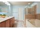 The bathroom features double sinks, an enclosed shower, and a soaking tub at 411 Mountain View Ln, Woodstock, GA 30188