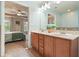 Light blue bathroom with double sinks and wooden cabinetry at 411 Mountain View Ln, Woodstock, GA 30188