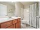 Standard bathroom with combination tub and shower, toilet, and wood vanity at 411 Mountain View Ln, Woodstock, GA 30188