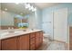 Light blue bathroom features double sink vanity with quartz countertop and wood cabinets at 411 Mountain View Ln, Woodstock, GA 30188